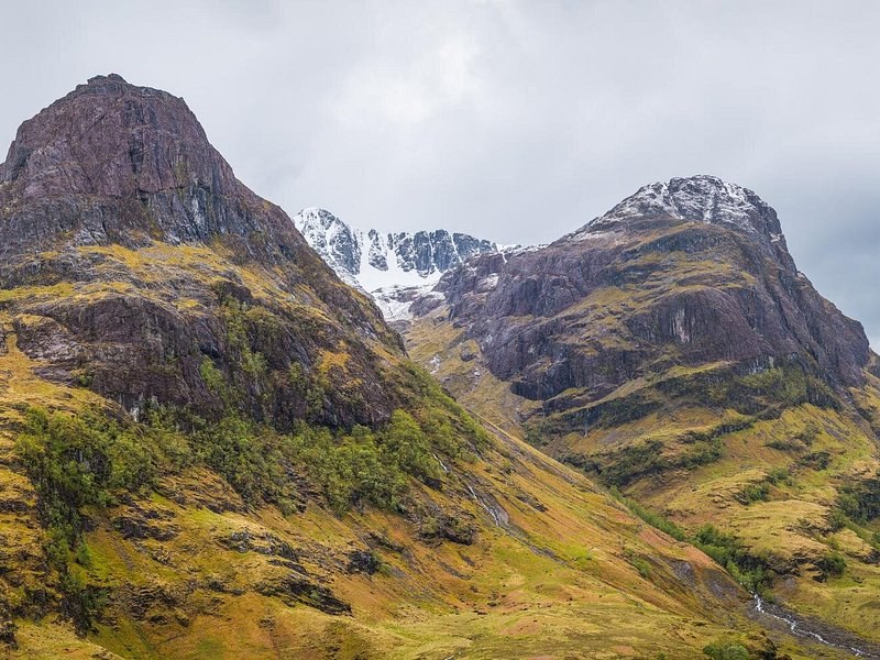 Three steep ridges in a Highland glen, snow in the corries behind